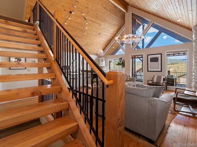 152 Bergamot Dr, Tabernash, CO 80478 - staircase with wood ceiling with exposed beams, wood-type flooring, high vaulted ceiling, and a chandelier