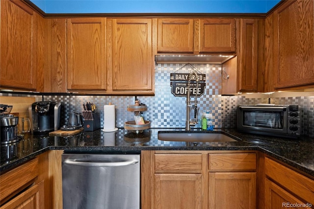 kitchen featuring dark stone countertops, stainless steel dishwasher, and tasteful backsplash