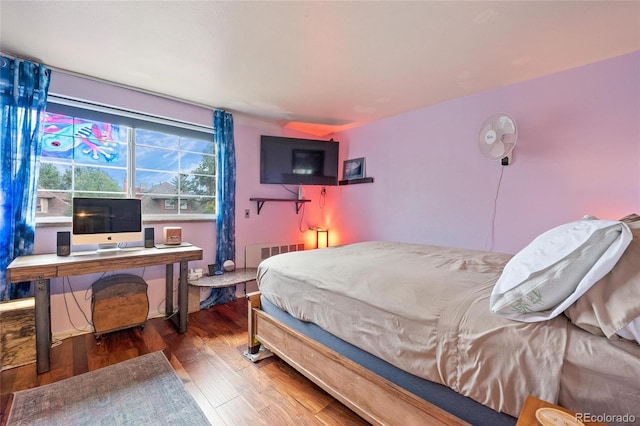 bedroom with dark hardwood / wood-style floors