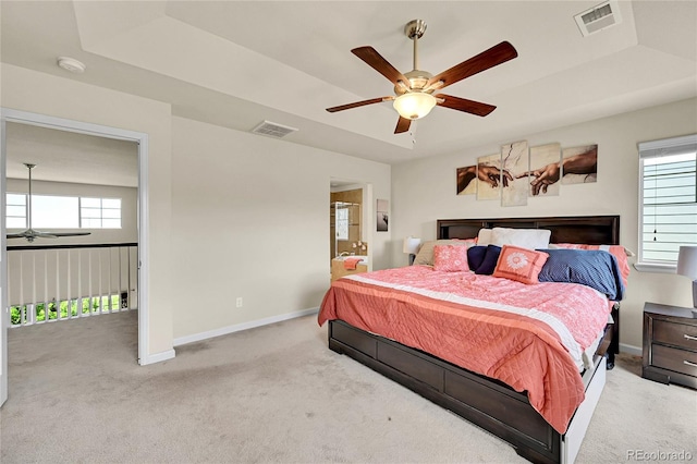 5722 S Flat Rock Way, Aurora, CO 80016 - carpeted bedroom featuring a raised ceiling, ceiling fan, and ensuite bath