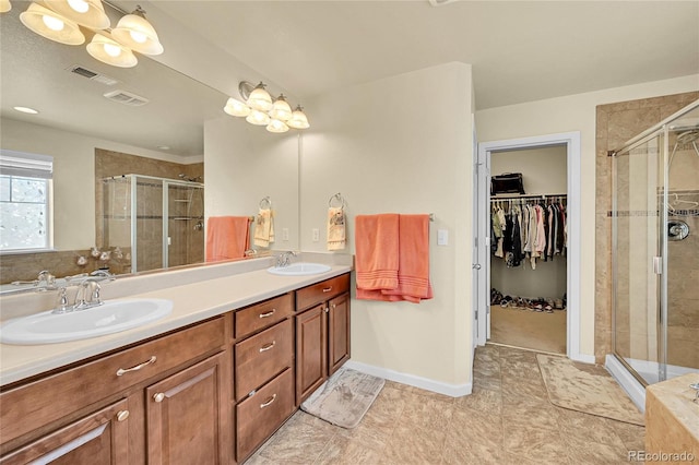 5722 S Flat Rock Way, Aurora, CO 80016 - full bathroom with a stall shower, double vanity, and a walk in closet