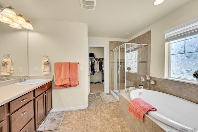 5722 S Flat Rock Way, Aurora, CO 80016 - full bath with a stall shower, vanity, a bath, a spacious closet, and tile patterned floors