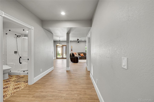 5722 S Flat Rock Way, Aurora, CO 80016 - hall with light wood finished floors, a textured wall, and recessed lighting