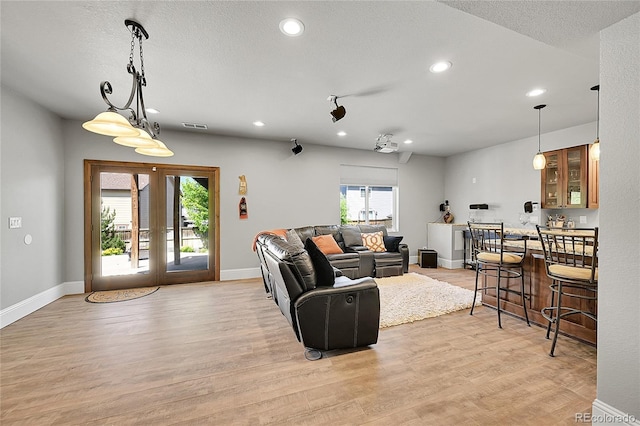5722 S Flat Rock Way, Aurora, CO 80016 - living area featuring recessed lighting, light wood finished floors, and a textured ceiling