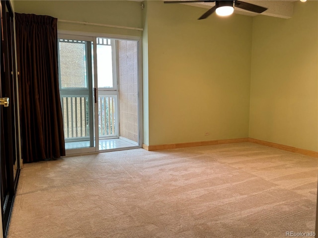 unfurnished room featuring ceiling fan and light colored carpet