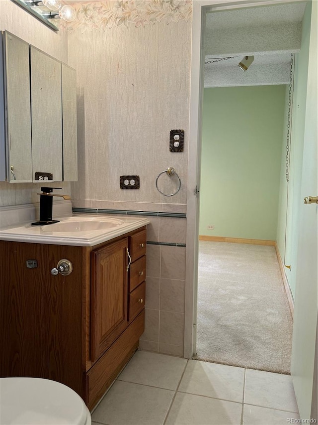 bathroom featuring tile patterned floors, vanity, and a textured ceiling