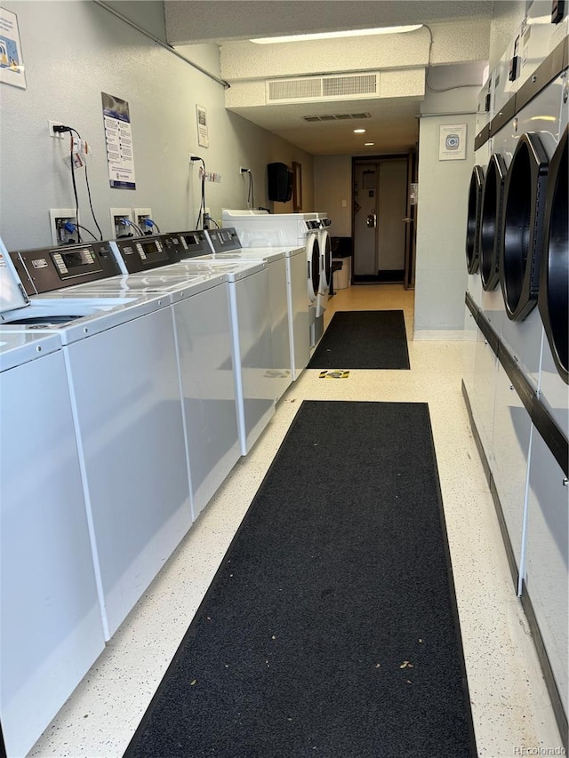 washroom featuring washing machine and clothes dryer