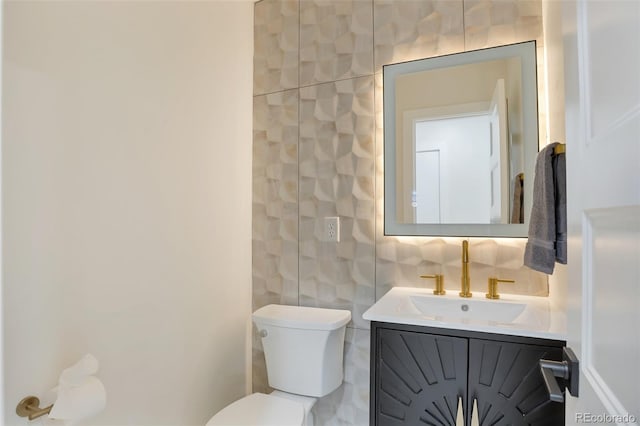 1130 S Harrison St, Denver, CO 80210 - bathroom featuring vanity, toilet, and tile walls