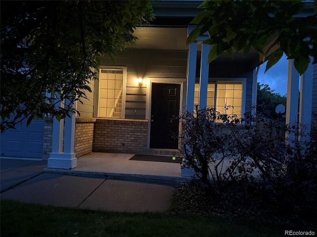 8416 S Reed St, Littleton, CO 80128 - doorway to property featuring brick siding