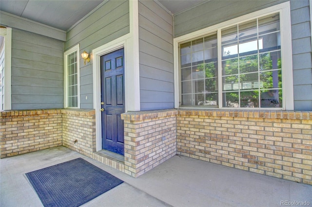 8416 S Reed St, Littleton, CO 80128 - entrance to property featuring covered porch and brick siding