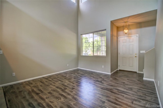 8416 S Reed St, Littleton, CO 80128 - entrance foyer featuring plenty of natural light, dark wood-style flooring, baseboards, and a high ceiling