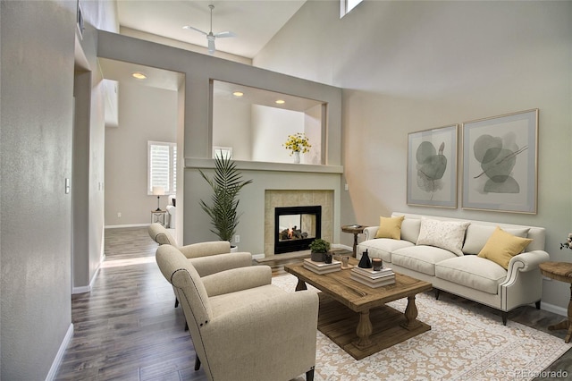 8416 S Reed St, Littleton, CO 80128 - living room featuring wood finished floors, baseboards, a fireplace, recessed lighting, and a high ceiling