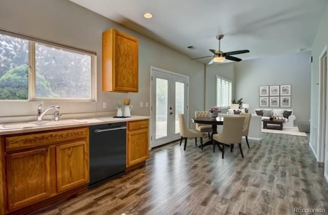 8416 S Reed St, Littleton, CO 80128 - kitchen featuring black dishwasher, a sink, wood finished floors, light countertops, and brown cabinets
