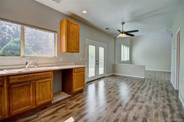 8416 S Reed St, Littleton, CO 80128 - kitchen featuring a sink, wood finished floors, brown cabinetry, light countertops, and recessed lighting
