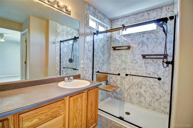 8416 S Reed St, Littleton, CO 80128 - full bath featuring a marble finish shower, vanity, and a ceiling fan