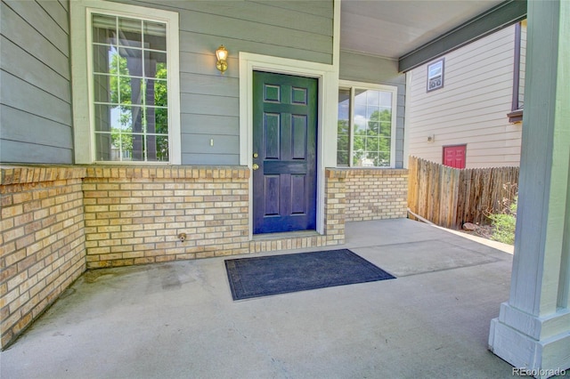 8416 S Reed St, Littleton, CO 80128 - doorway to property with a porch and brick siding