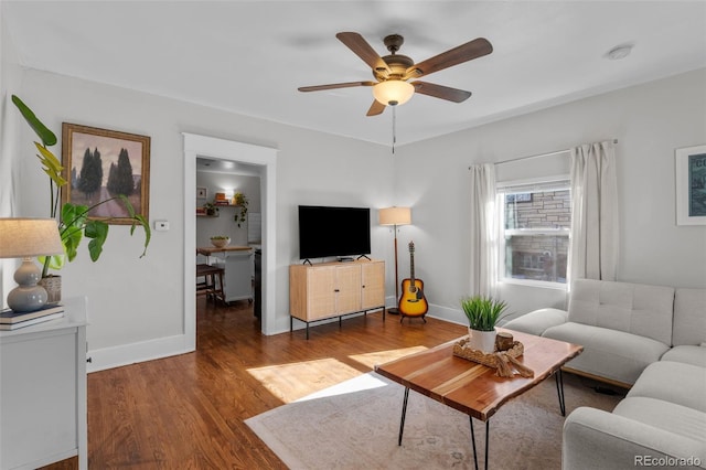 living room featuring ceiling fan and hardwood / wood-style floors