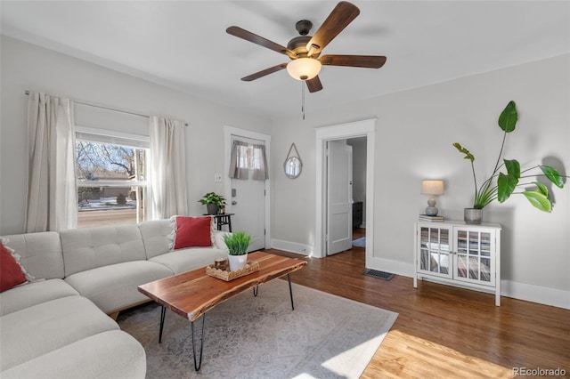 living room featuring wood-type flooring and ceiling fan