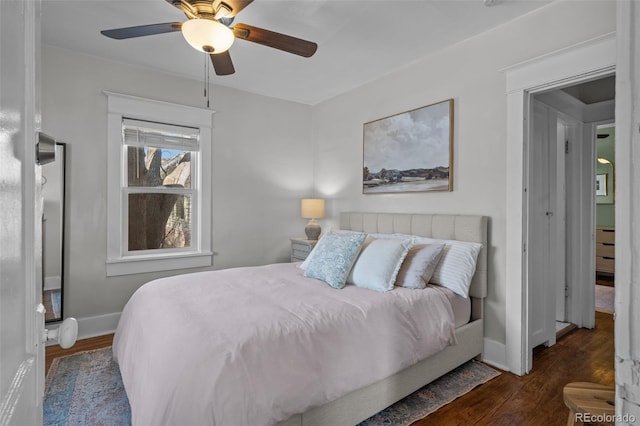 bedroom with ceiling fan and dark hardwood / wood-style floors