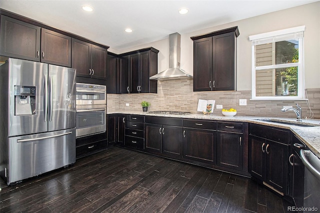 3522 Harvard Pl, Broomfield, CO 80023 - kitchen with light stone countertops, dark wood-style floors, wall chimney exhaust hood, a sink, and appliances with stainless steel finishes