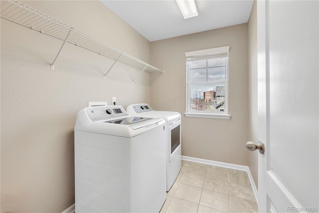 3522 Harvard Pl, Broomfield, CO 80023 - laundry room with washer and dryer, light tile patterned floors, laundry area, and baseboards