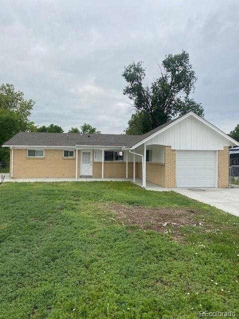 8220 E 104th Way, Henderson, CO 80640 - single story home featuring brick siding, an attached garage, a front yard, driveway, and board and batten siding