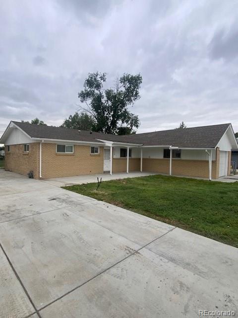 8220 E 104th Way, Henderson, CO 80640 - ranch-style house with brick siding, a front yard, a garage, and concrete driveway
