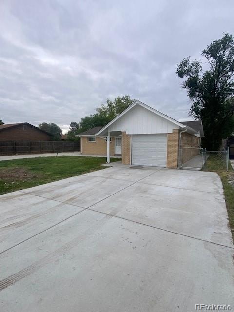 8220 E 104th Way, Henderson, CO 80640 - ranch-style home featuring a garage, brick siding, and driveway