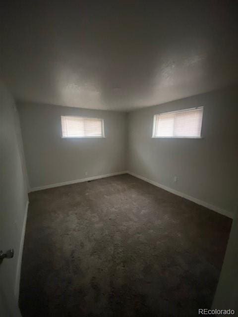 8220 E 104th Way, Henderson, CO 80640 - spare room with dark carpet and baseboards