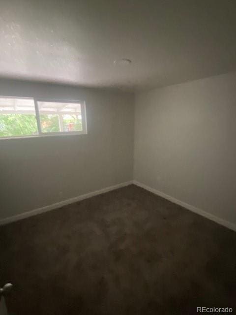 8220 E 104th Way, Henderson, CO 80640 - spare room with baseboards and dark colored carpet