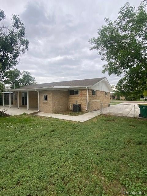8220 E 104th Way, Henderson, CO 80640 - rear view of property with central AC unit, brick siding, and a patio area