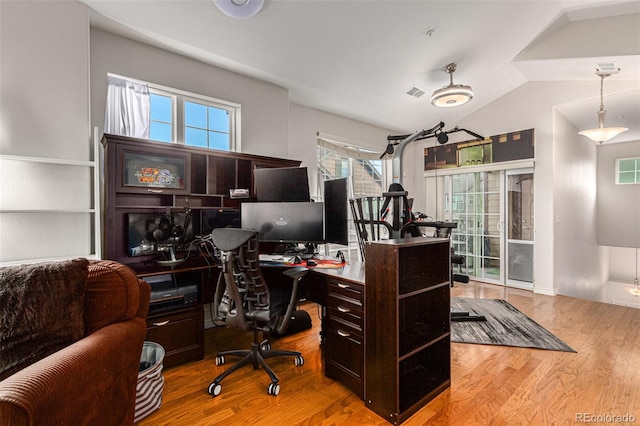 office area featuring light wood-type flooring and vaulted ceiling