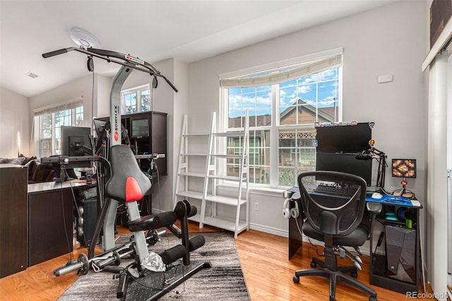 home office with lofted ceiling and hardwood / wood-style floors