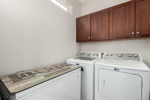 laundry room with cabinets and washer and clothes dryer