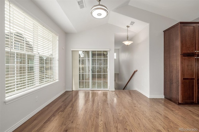 unfurnished room with lofted ceiling and light hardwood / wood-style flooring