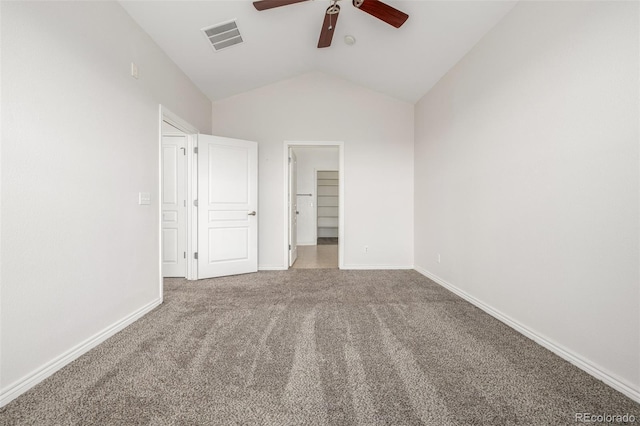 unfurnished bedroom with ceiling fan, vaulted ceiling, carpet, and a spacious closet