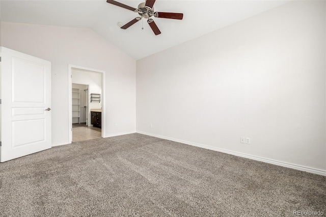 unfurnished bedroom featuring vaulted ceiling, carpet flooring, ceiling fan, and ensuite bath