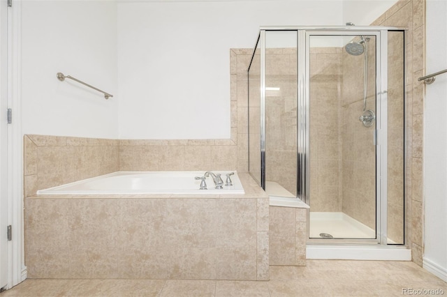 bathroom with separate shower and tub and tile patterned flooring