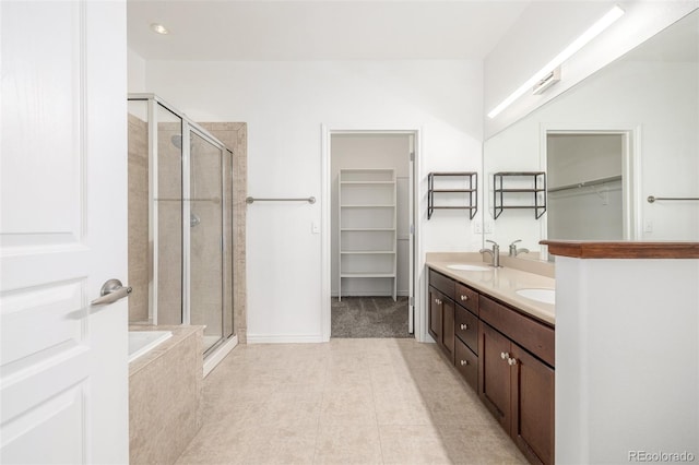 bathroom featuring tile patterned flooring, vanity, and plus walk in shower