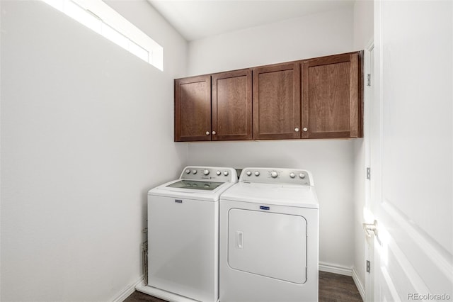 washroom with cabinets, washer and clothes dryer, and dark hardwood / wood-style flooring