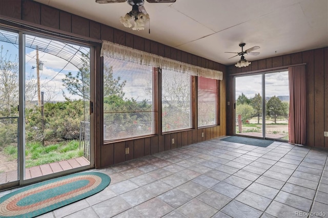 unfurnished sunroom with wooden walls