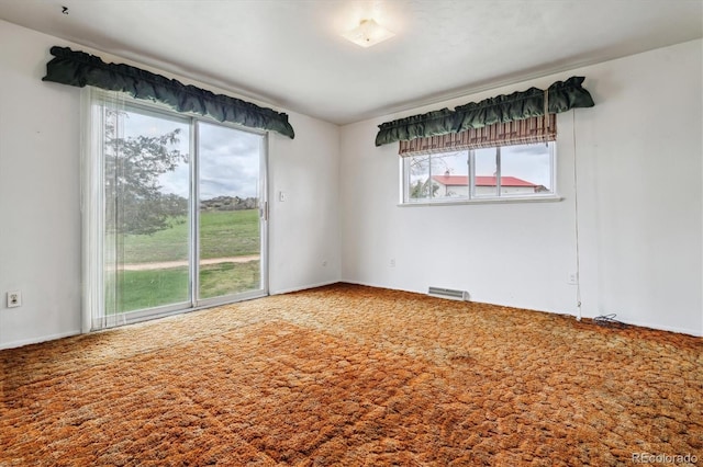 carpeted empty room with visible vents
