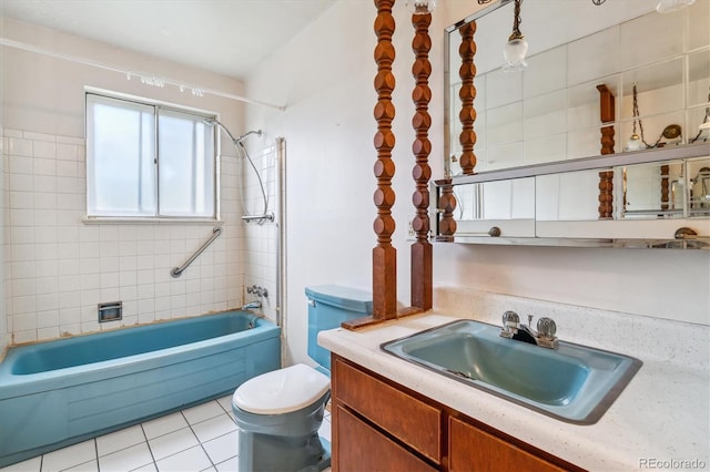bathroom featuring tile patterned flooring, toilet, bathtub / shower combination, and vanity