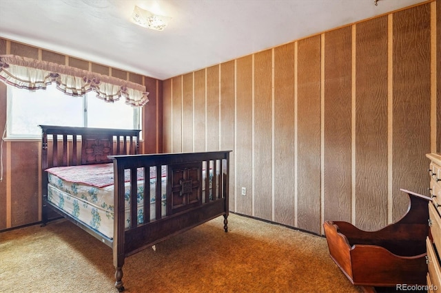 carpeted bedroom with wood walls