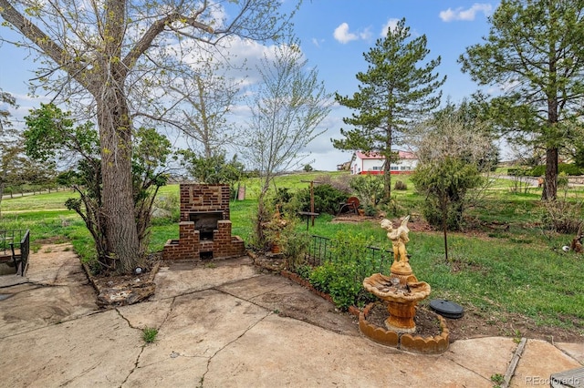 view of patio / terrace featuring an outdoor brick fireplace
