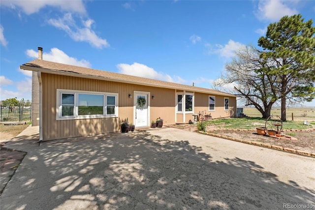 view of front of home featuring roof with shingles and a patio