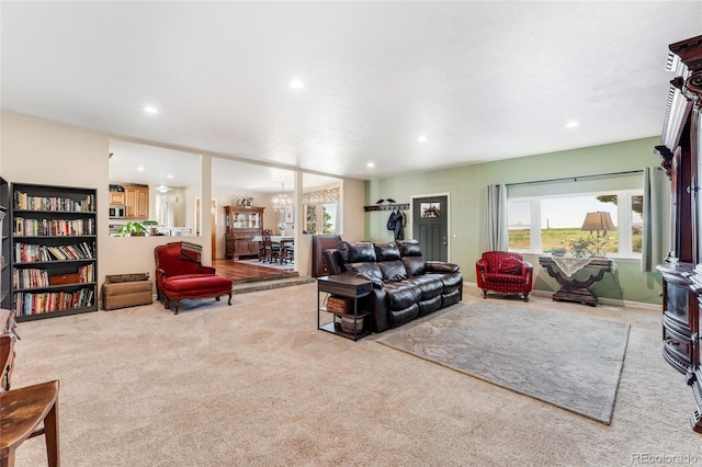 living room with a notable chandelier, carpet flooring, and recessed lighting