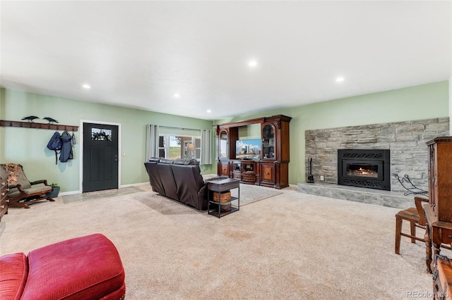 carpeted living area featuring baseboards, recessed lighting, and a fireplace