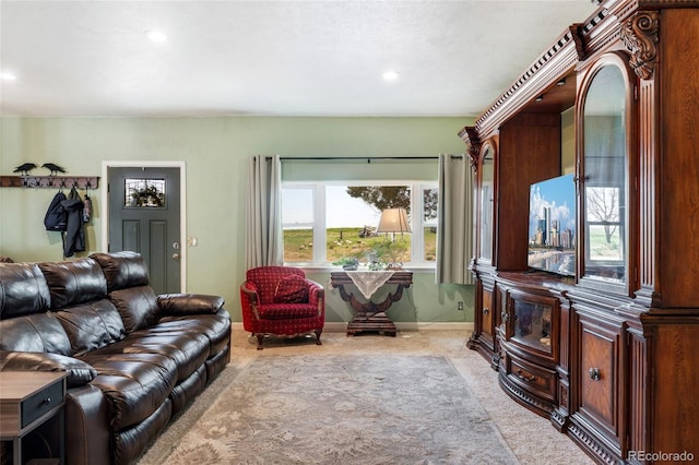 living area featuring recessed lighting, baseboards, and light colored carpet