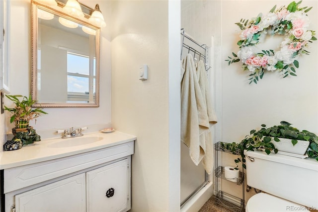 full bath with a shower stall, toilet, and vanity